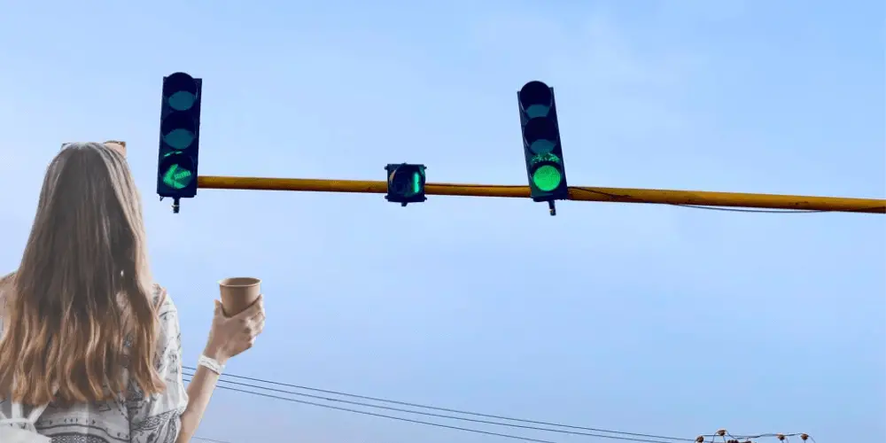 alt="An image of travel blogger looking at the traffic light"